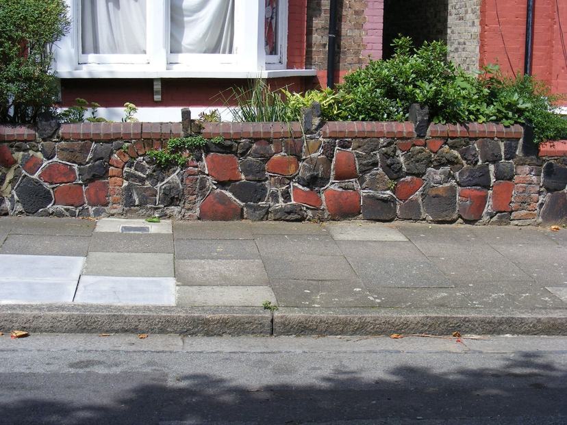Finished stone wall along a front walk