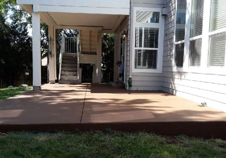 Finished concrete patio under a deck